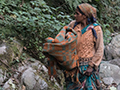Woman Walking Along River, India